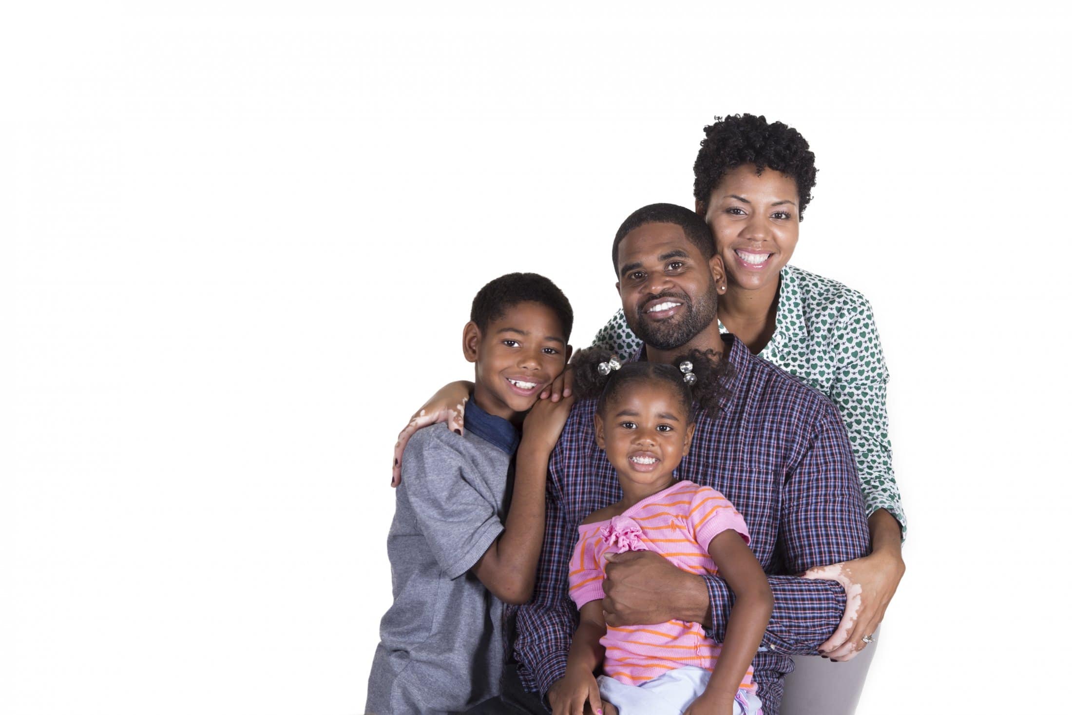 A family posing with bright smiles, showcasing the aesthetic services of family dentistry at Pike District Smiles.