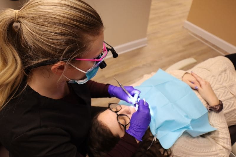A dentist performing treatment at Pike district Smiles. Dental Special Offers in Bethesda
