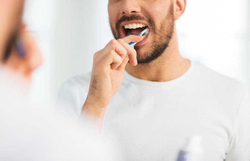Patient brushing his teeth.