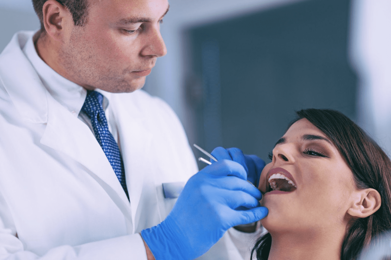 Dentist performing root canal treatment on patient.