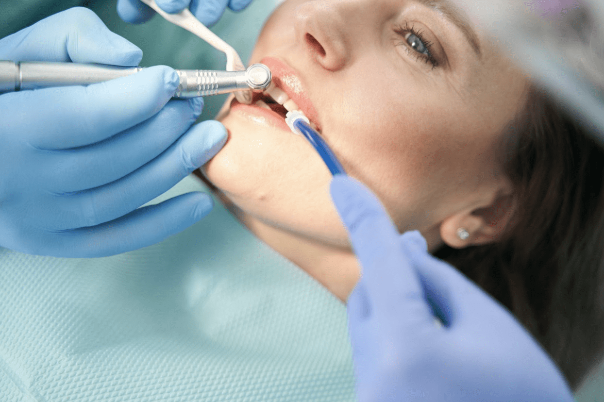 Female patient undergoing teeth whitening treatment.