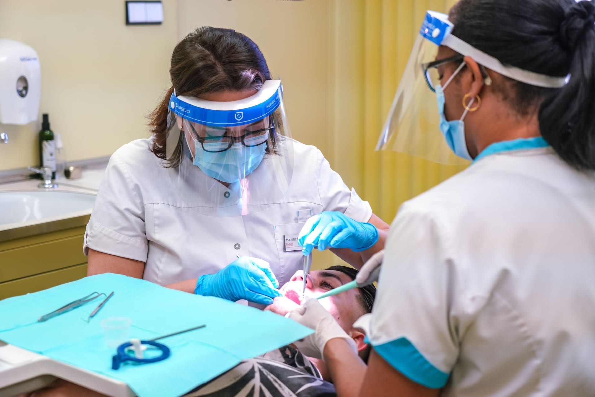 Two dentists providing sophisticated treatment to the patient.