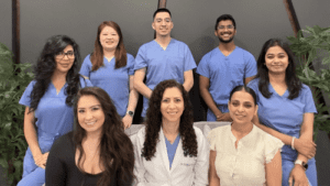 A professional team of dentists and helping staff posing for beautiful picture at Pike District Smiles. The best dentists and dental services place