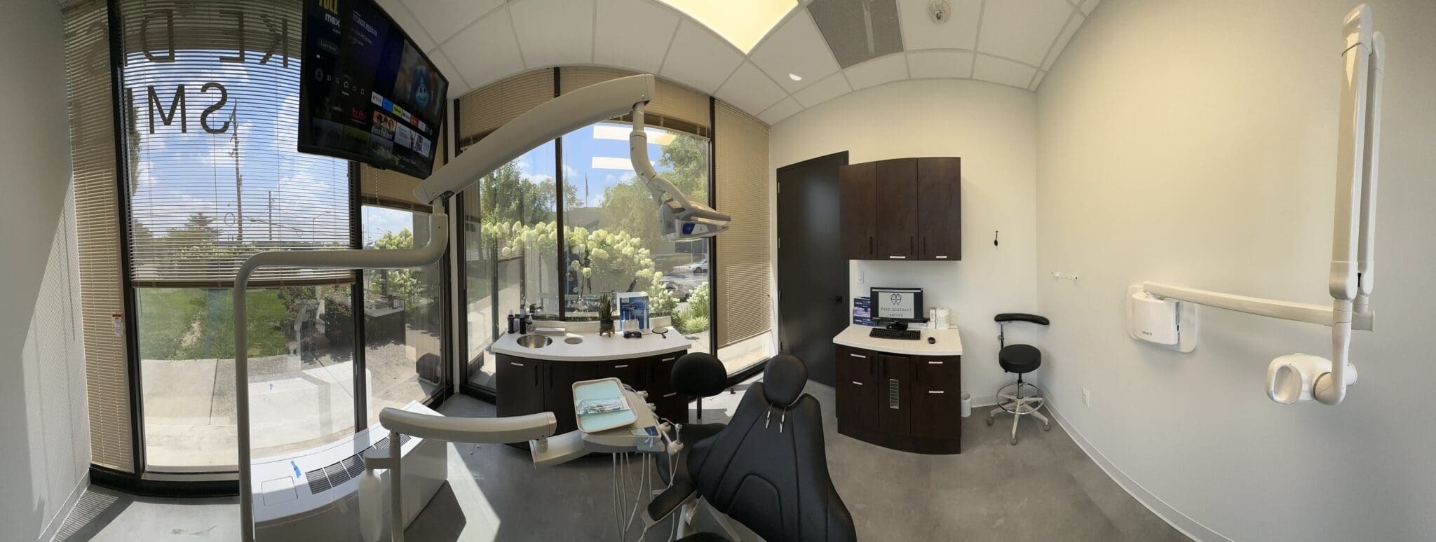 Interior photo of Pike District Smiles clinic, featuring dental chair and two examination desks.